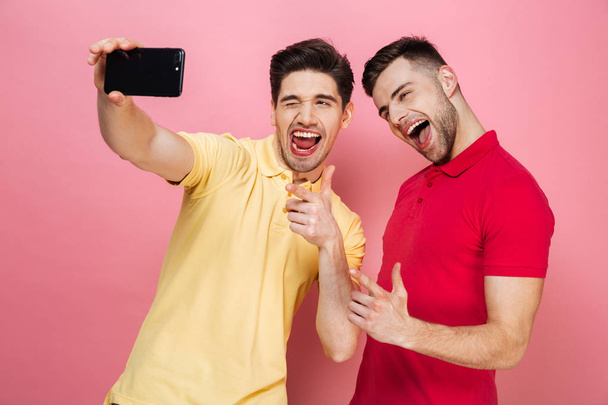 Portrait of a happy gay couple taking a selfie - Photo, Image