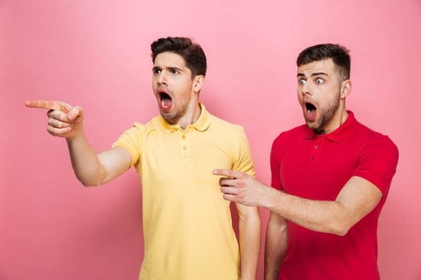 Portrait of a shocked gay couple - 写真・画像