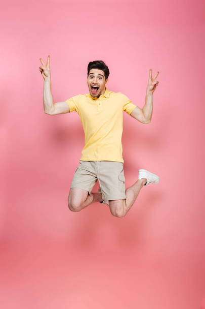 Full length portrait of an excited young man jumping - Zdjęcie, obraz