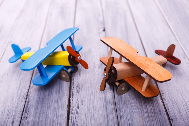 Childrens toy airplanes on the wooden background. Game concept. - Photo, Image