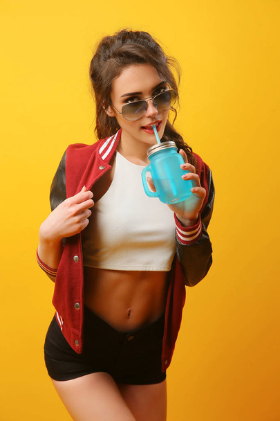Woman in stylish jacket with drinking jar - Фото, зображення