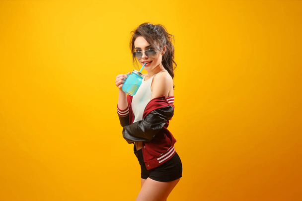 Woman in stylish jacket with drinking jar - Foto, afbeelding