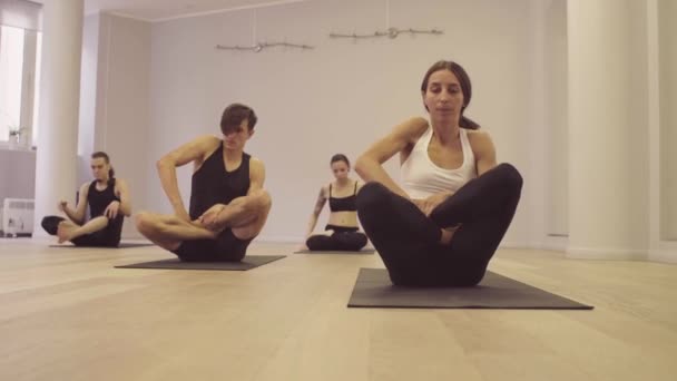 Yoga class. Ashtanga yoga. Garbha pindasana. - Footage, Video