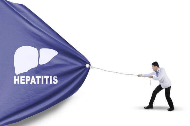 Asian physician pulling a banner with hepatitis word - Photo, image