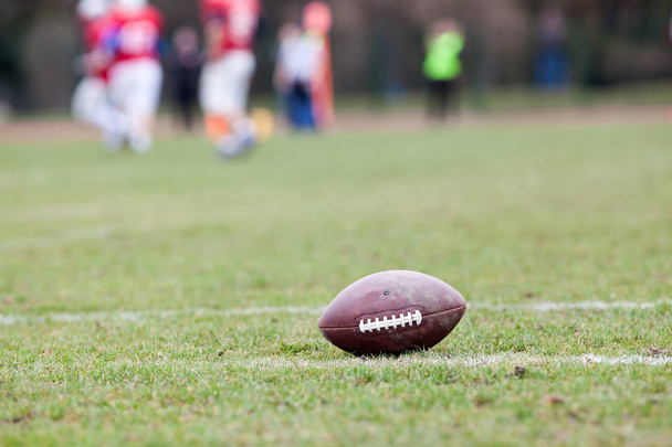 american football on the field - defocused players in the backgr - Фото, изображение