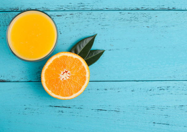 Glass of organic fresh orange juice with fruits - Фото, изображение