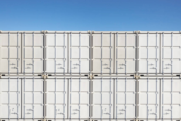 Stack of containers shipping at dockyard against blue sky - Photo, Image