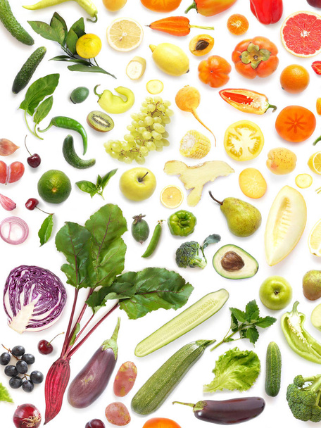 close-up photo of fresh fruits and vegetables set in rainbow colors on white table background - Foto, afbeelding