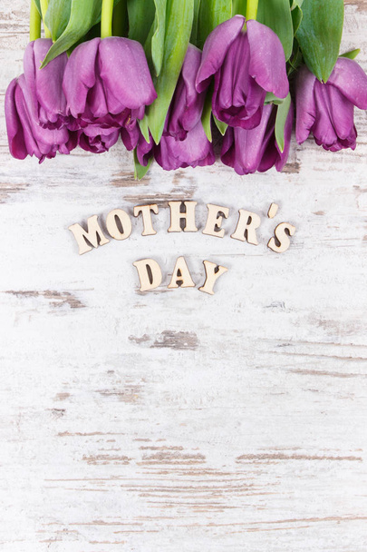 Bouquet of purple tulips for mother's day, copy space for text on boards - Foto, Bild