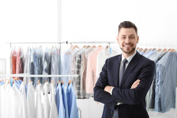 Portrait of young businessman at dry-cleaner's - Foto, afbeelding