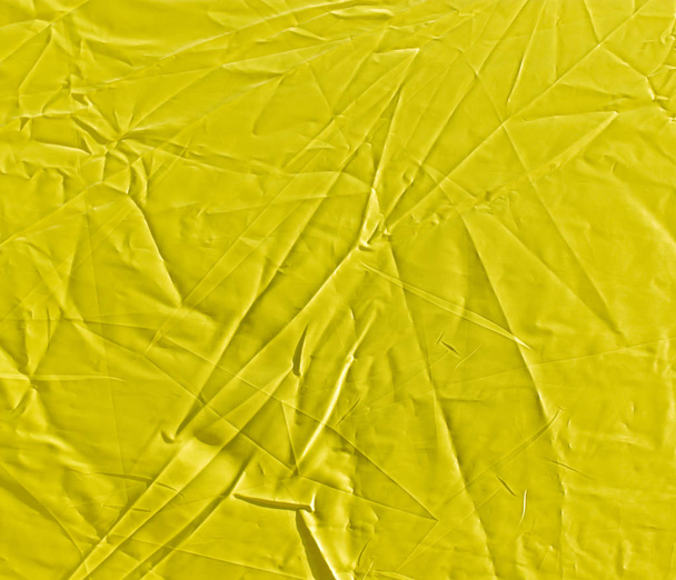 wrinkled yellow cloth as background - 写真・画像