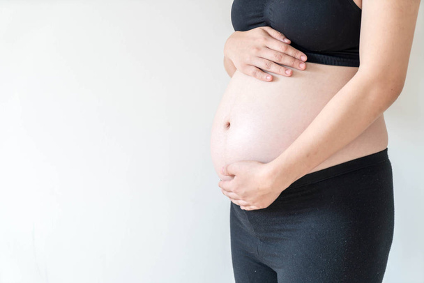 Pancia della donna incinta con le mani
 - Foto, immagini