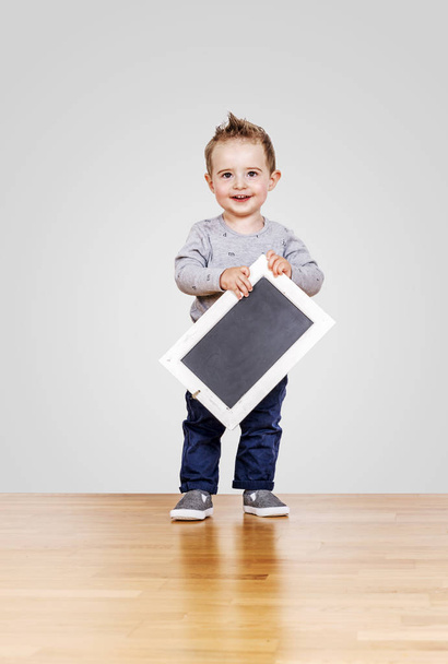 Boy with blackboard in hands - Φωτογραφία, εικόνα