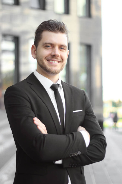 portrait of a successful businessman on the background of an office building - Fotó, kép