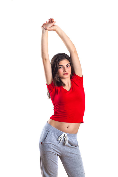 beautiful brunette teenager in red shirt and in sports pantsis i - Fotografie, Obrázek