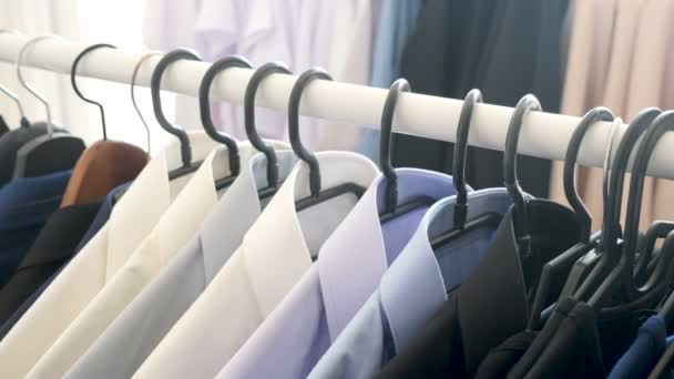Hanger with male business clothes in a store - Footage, Video