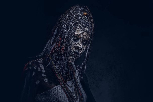 肌とドレッドヘア暗い背景に怖いアフリカのシャーマン、石化したと女性の肖像画が入っています。メイクのコンセプト. - 写真・画像
