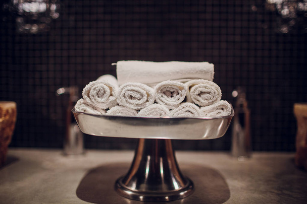 Restroom in hotel or restaurant, focus on towels white - Фото, изображение