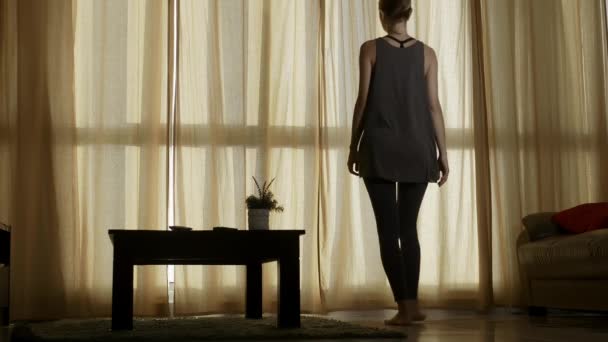 Young woman opening window curtains. - Video, Çekim