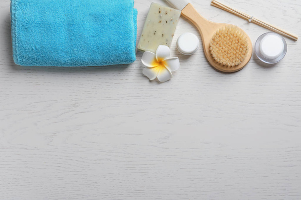 Flat lay composition with spa cosmetics and towel on wooden background - Zdjęcie, obraz