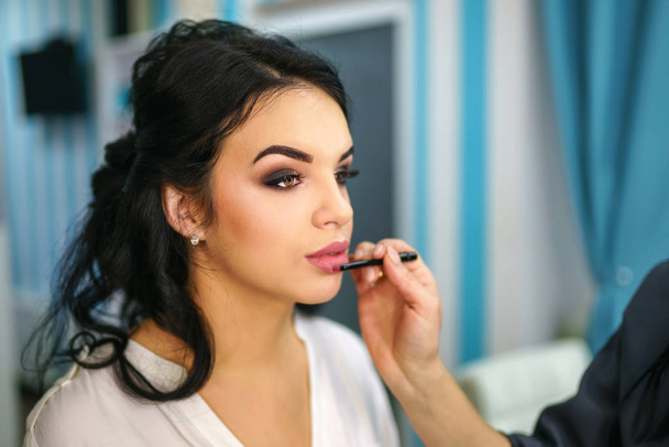 Beautiful bride on the makeup before wedding ceremony - Photo, image