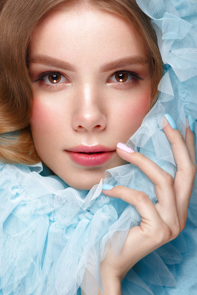Beautiful girl with light make-up and gentle manicure in blue clothes. Beauty face. Design nails. - Fotoğraf, Görsel