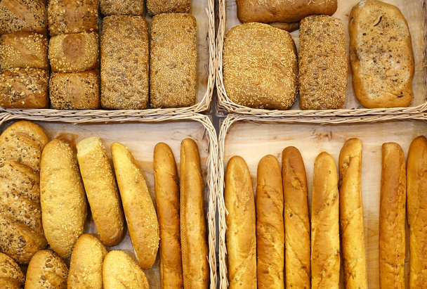 Different kinds of bread in baskets top view.                     - Фото, зображення