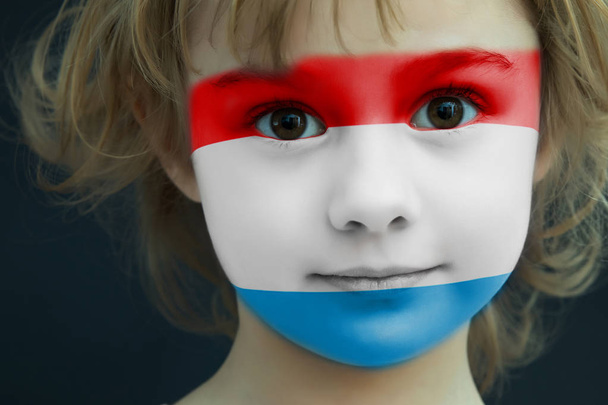 Child with a painted flag of Luxembourg - Fotografie, Obrázek