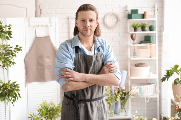 Portrait of handsome male florist at workplace - Foto, afbeelding