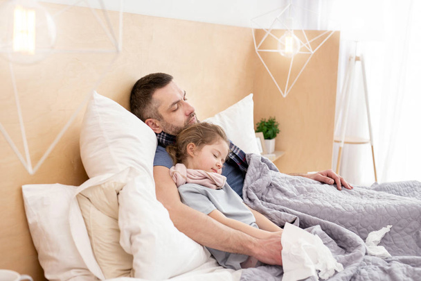 Unhealthy father and daughter sleeping together  - Photo, Image