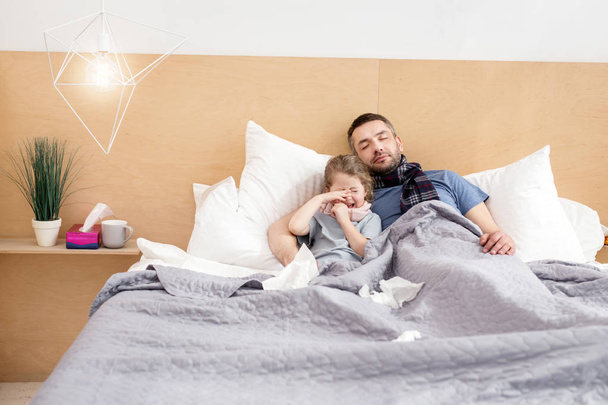 Unwell father and daughter sleeping together  - Photo, image