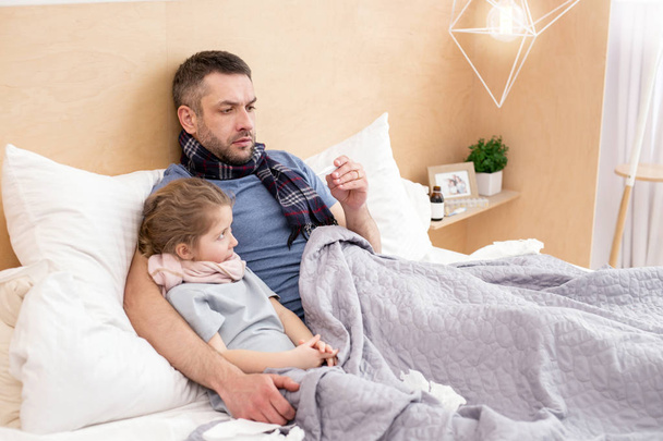 Sick daddy and daughter having a fever  - Fotoğraf, Görsel