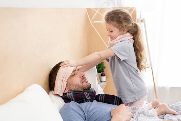Caring daughter taking care of her daddy  - Fotoğraf, Görsel