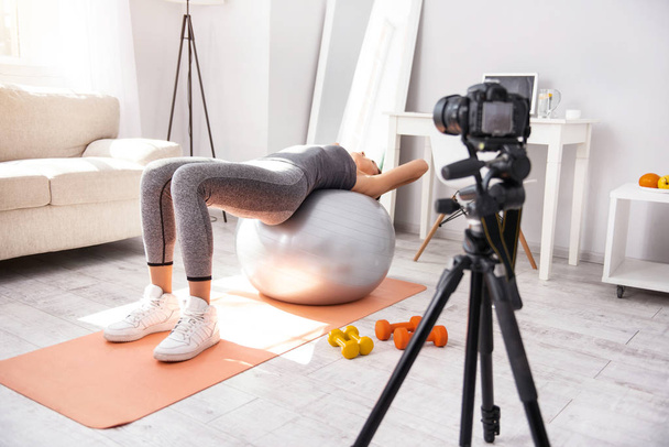 Fit young woman stretching on a yoga ball - Фото, изображение