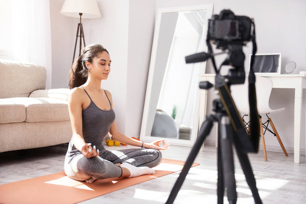 Peaceful woman filming yoga practice tutorial - Foto, Imagem