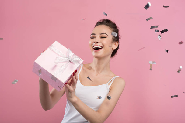 Cheerful young woman is enjoying her present - Fotografie, Obrázek