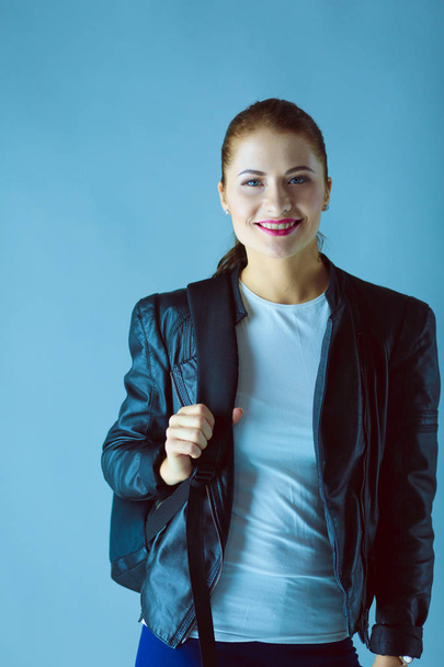 portrait of beautiful young brunette woman in stylish black jacket on gray. - Foto, Imagem
