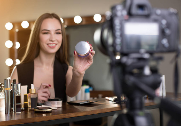Cheerful beauty blogger is demonstrating new product - Foto, Bild