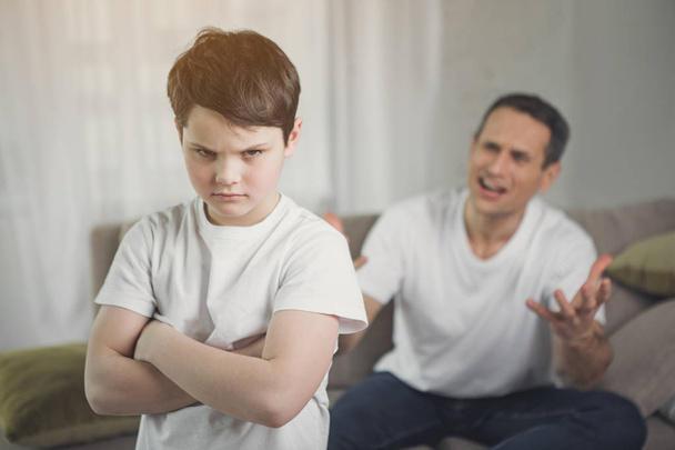 Offended child hearing irritated dad shouting - Photo, image