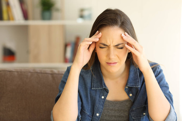 Woman complaining suffering migraine at home - Fotó, kép