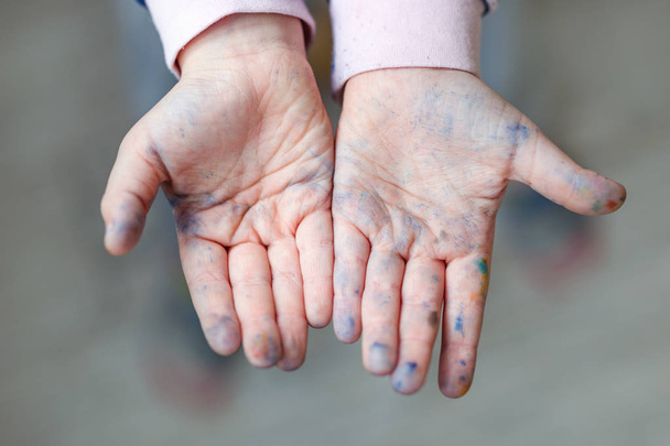 Happy little kid showing hands dirty with paint. Enjoying art and painting concept - Fotografie, Obrázek