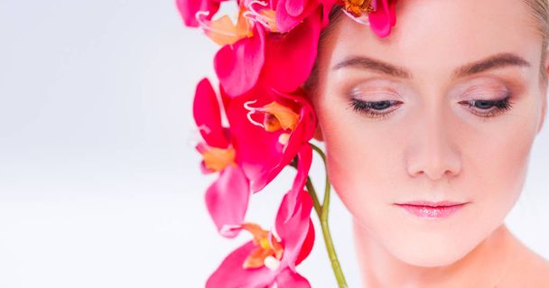 Young beauty woman with flower near face - Zdjęcie, obraz