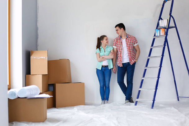 Portrait of young couple moving in new home. Young couple - Fotoğraf, Görsel