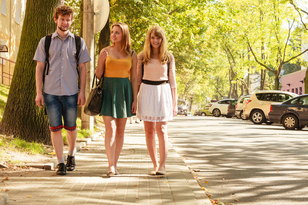 Three people friends walking outdoor. - Photo, image
