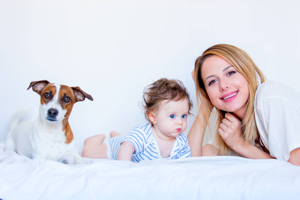mother, child and dog in bed - Photo, Image