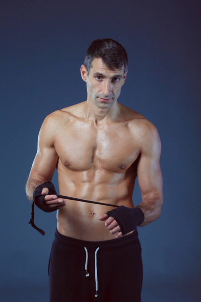 portrait of hand wrapping half nude boxer. Personal fitness instructor. Personal training. - Фото, зображення