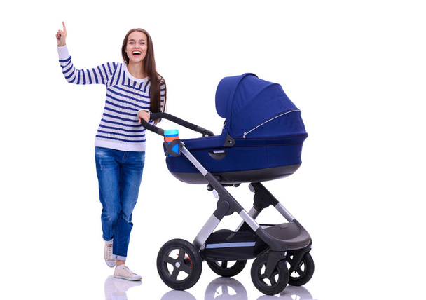 Full length portrait of a mother with a stroller, isolated on white background. Young mom - Fotoğraf, Görsel