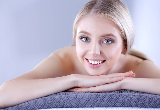 Young woman lying on a massage table,relaxing . Woman. Spa salon - Photo, Image