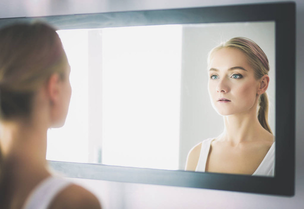 face of young beautiful healthy woman and reflection in the mirror - Photo, Image