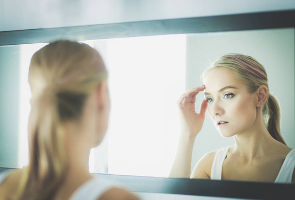 face of young beautiful healthy woman and reflection in the mirror - Фото, изображение